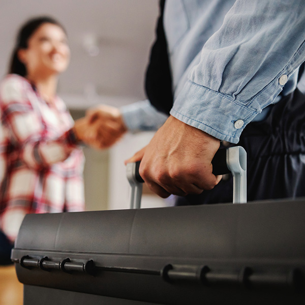 Woman shaking hands with a repairman while standing at home